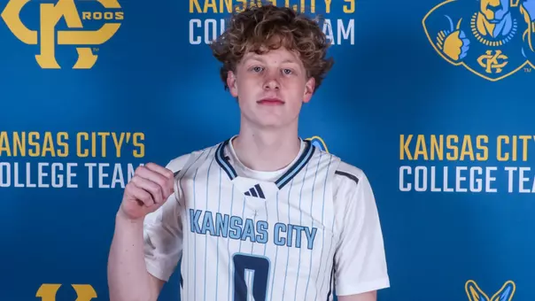 Elliot Moskowitz shows off the Kansas City jersey in front of a Roos backdrop