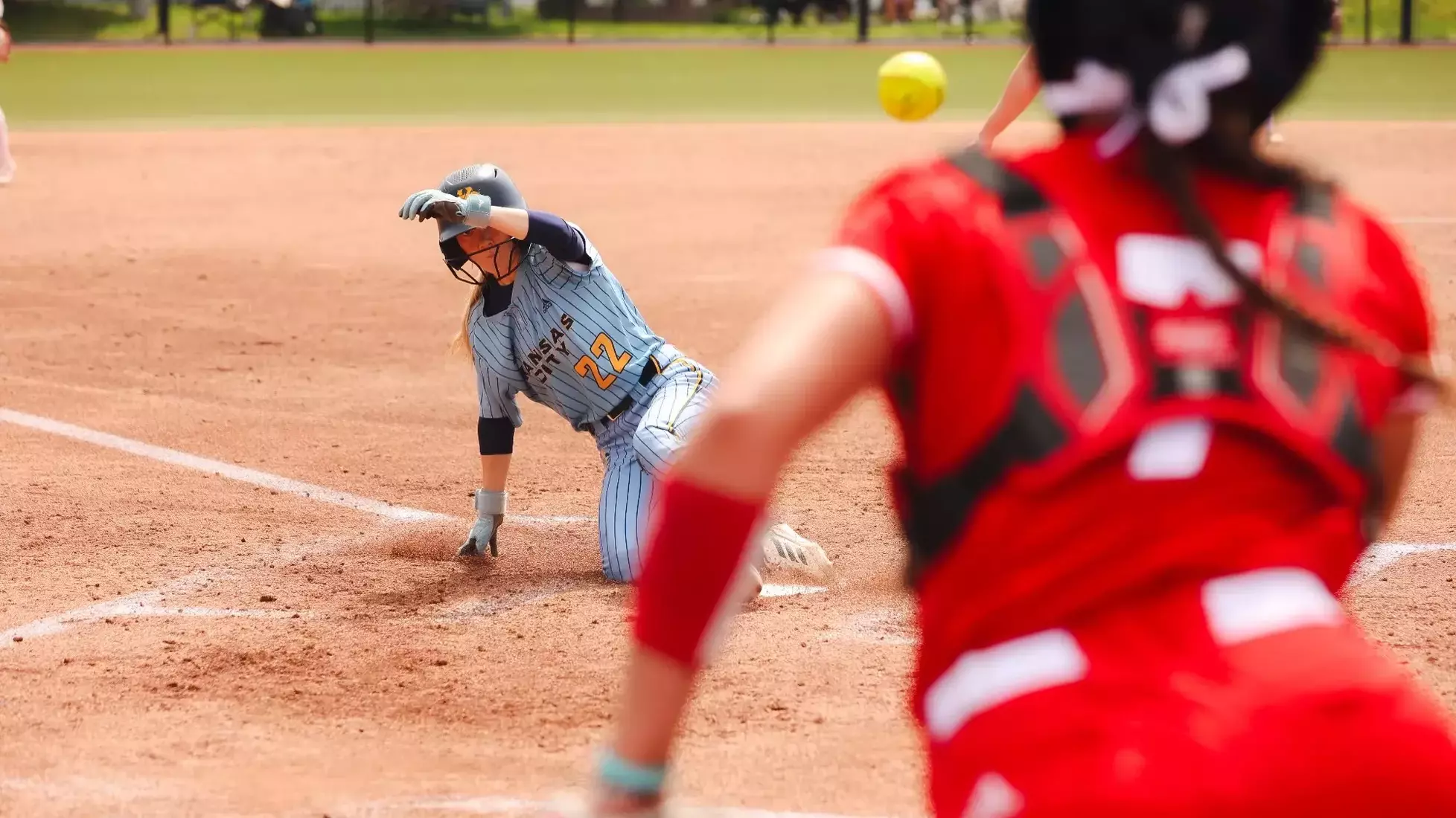 Ella Husak slides into home and scores a run against South Dakota on Apr. 26