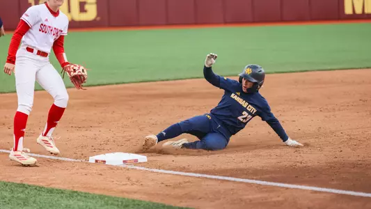 Elleana Navarro slides feet-first into third base
