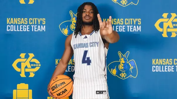 A photo of Jaylen Smith signaling 'Roo Up' towards the camera