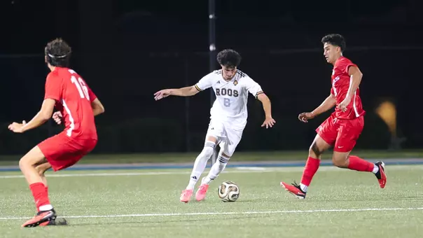 Mathias Baucher dribbles the ball upfield and through a pair of UNLV defenders