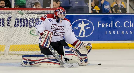 Connor Hellebuyck making a save against Notre Dame