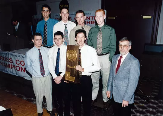 1991 cross country team with NCAA trophy.