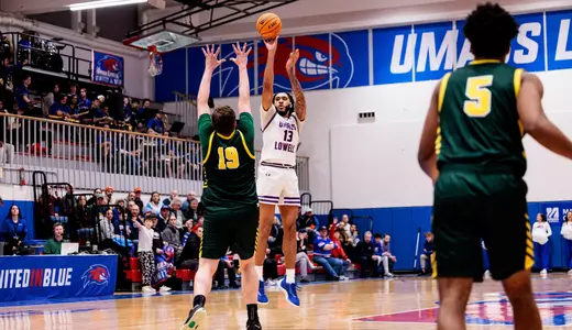 Shawn Simmons shooting a three over a Vermont defender