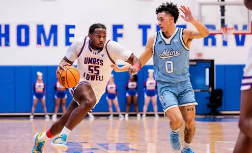 JJ Massaquoi dribbling against a Maine defender