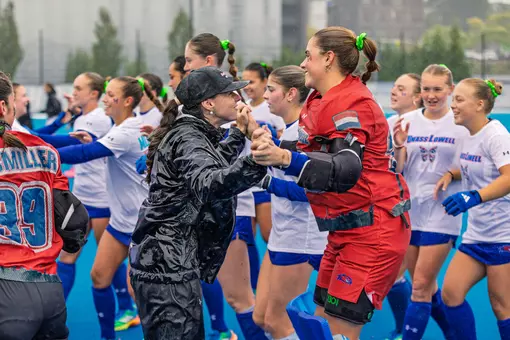 Field hockey players high five during intros