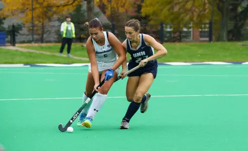 Rena Pistilli fighting for ball against UNH defender