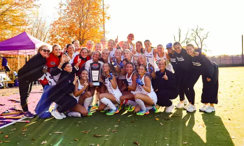 UMass Lowell field hockey team photo with championship trophy