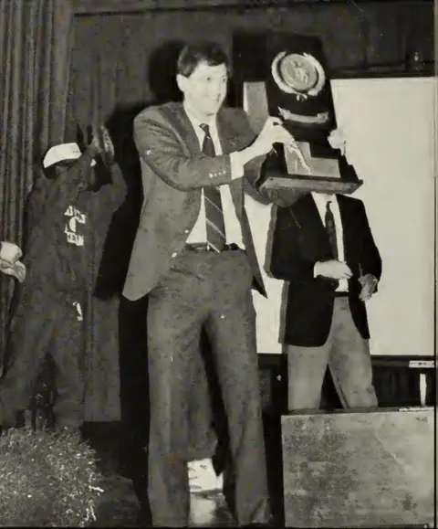 Don Doucette holding 1988 NCAA Tournament Trophy