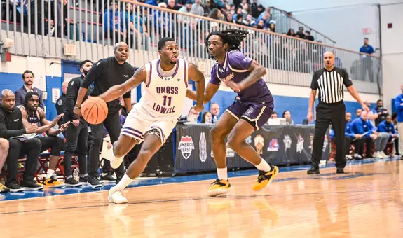Xavier Spencer dribbling past Albany defender