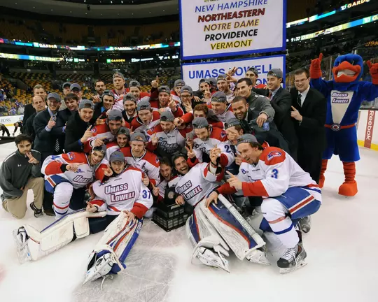 River Hawks pose with 2014 Hockey East Championship banner