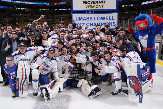 River Hawks pose with 2017 Hockey East Championship banner