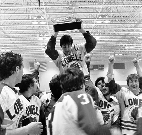 Dean Jenkins holding trophy being carried on teammates shoulders