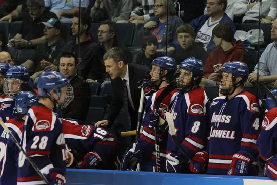 Coach Norm Bazin talking to players on the bench