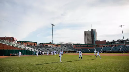 UMass Lowell baseball players on their home ballpark Edward A. LeLacheur Park warming up before a game