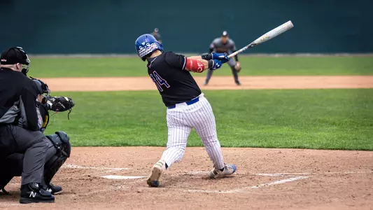 UMass Lowell baseball player swinging the bat during his plate appearance as the ball is thrown down into the strike zone