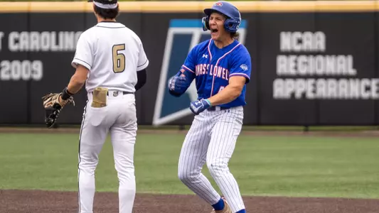 UMass Lowell Baseball player yelling and celebrating on first base after recording a hit in the game against Bryant