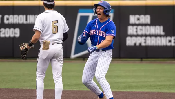 UMass Lowell Baseball player yelling and celebrating on first base after recording a hit in the game against Bryant