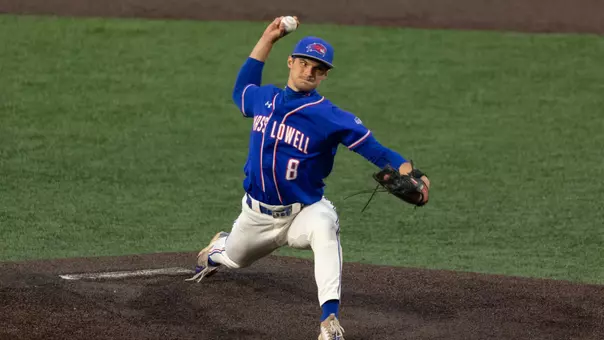 UMass Lowell baseball pitcher on the mound about to throw a pitch down the strike zone to a batter