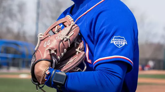 UMass Lowell baseball player's uniform and glove with accessories on his wrist