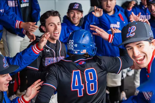 UMass Lowell Baseball - team celebration in the dugout after scoring a run