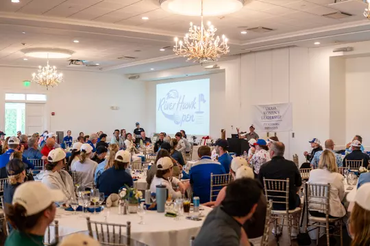 Attendees sitting in ballroom at River Hawk Open