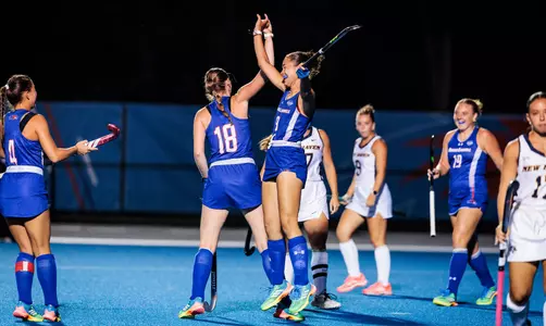Ella Sluder and Alice Van Hemelen high five