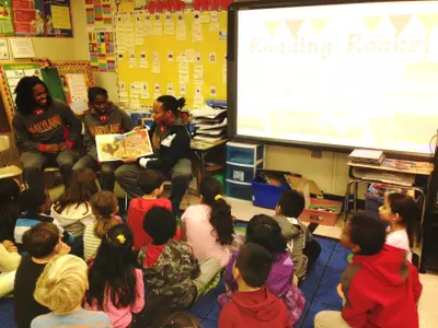 Terps Partake in 'Reading Rocks' at RCF Elementary