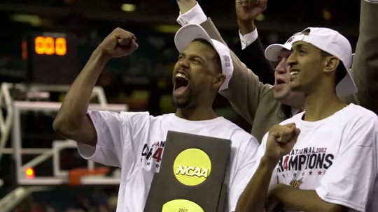 Byron Mouton and Drew Nicholas celebrate with the NCAA trophy