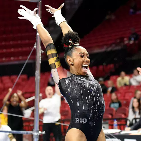 Tiara Wright celebrates her school-record 9.95 on the uneven bars