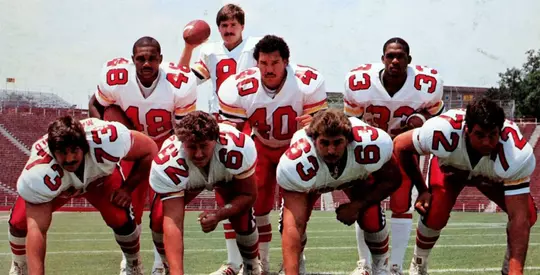 Rick Badanjek and teammates on the 1985 Media Guide cover