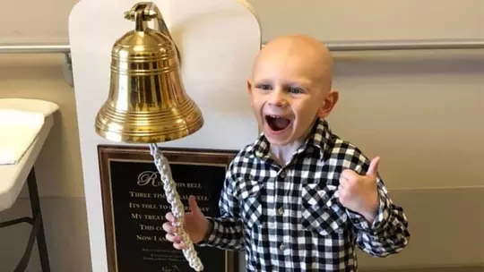 Griff Greenwalt rings the bell after final chemo treatment