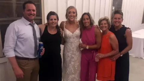 Kasey Asper with field hockey staff at her wedding