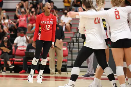 Libero Milan Gomillion (12) celebrates a point. Maryland Terrapins Volleyball vs. Virginia Cavaliers on Friday, Aug. 27, 2021. Zach Bland/Maryland Terrapins