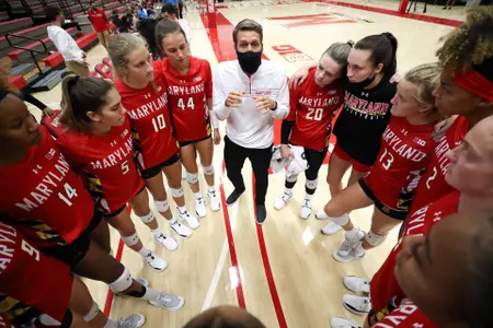 Head coach Adam Hughes speaks to the team before the game. Maryland Terrapins Volleyball vs. Central Connecticut State Blue Devils at The Pavilion in College Park, MD on Saturday, Aug. 28, 2021. Zach Bland/Maryland Terrapins