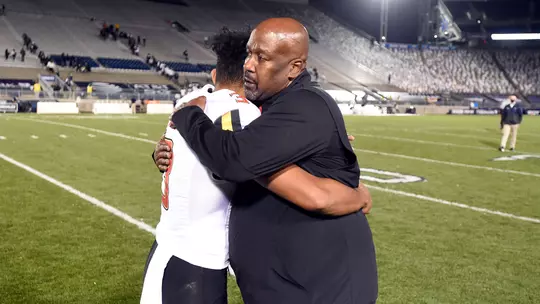 Taulia Tagovailoa and Michael Locksey embrace following the Terps' win at Penn State in 2020