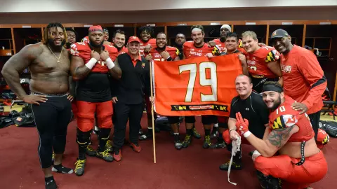 Brian Plummer with the offensive line celebrating Jordan McNair