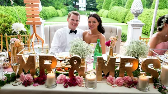Tom Hanna III with his wife at their wedding