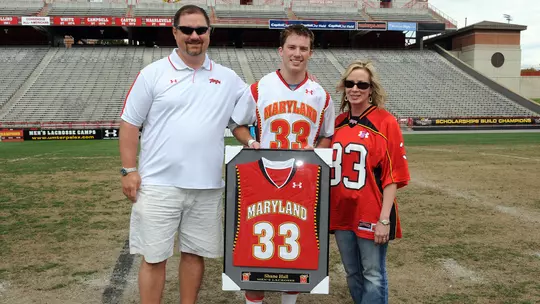 Shane Hall with parents on Senior Day