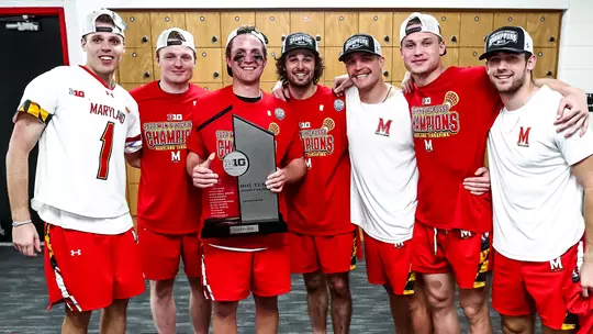 Jonathan Donville with teammates and the 2022 Big Ten trophy