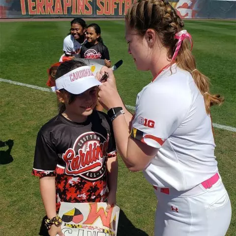 Katie Dustin signing an autograph