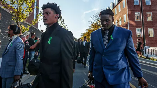 Maryland football players wearing green ribbons to support mental health awareness