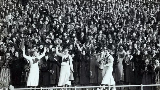 Cheerleaders leading the crowd at Homecoming in 1934