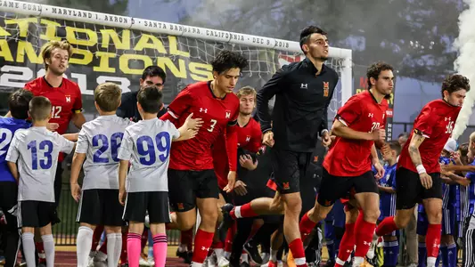 Men's Soccer Players Running out at Ludwig