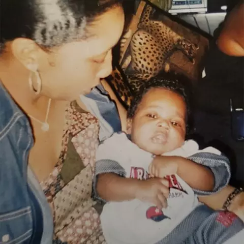 Shannon Felton holding Tai as a baby