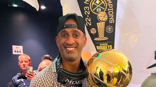 Drew Nicholas with the NBA Championship trophy