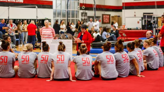 Dr. Pat Danhoff talks to the current Terrapins gymnastics team