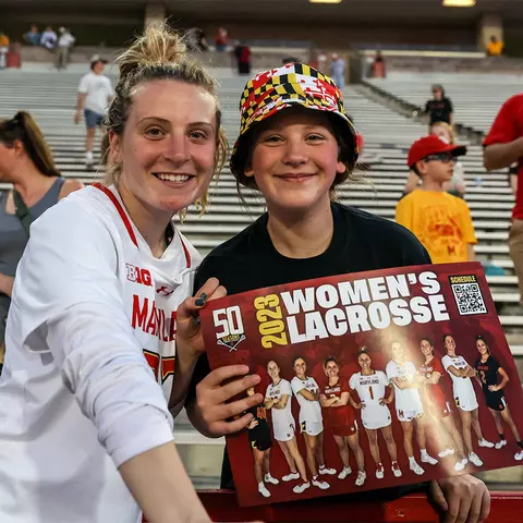 Emily Sterling with a fan after a Maryland women's lacrosse game