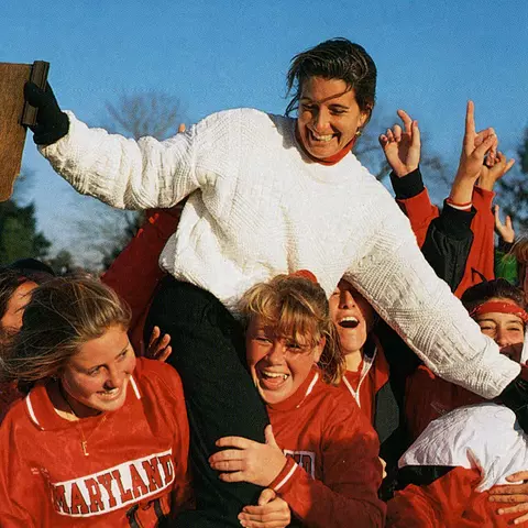 Maureen "Bean" Scott Dupcak helping lift Missy Meharg after winning 1993 Field Hockey championship