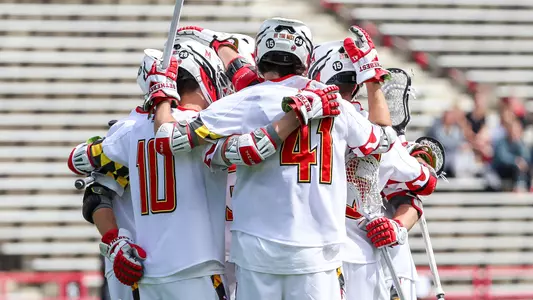 Men's Lacrosse student-athletes huddling vs. Michigan in 2023